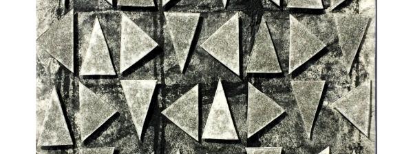 Gray triangles in a vertical grid, floating over a black and gray monoprint background. RT Black Sky, relief and collage print by Bill Brookover